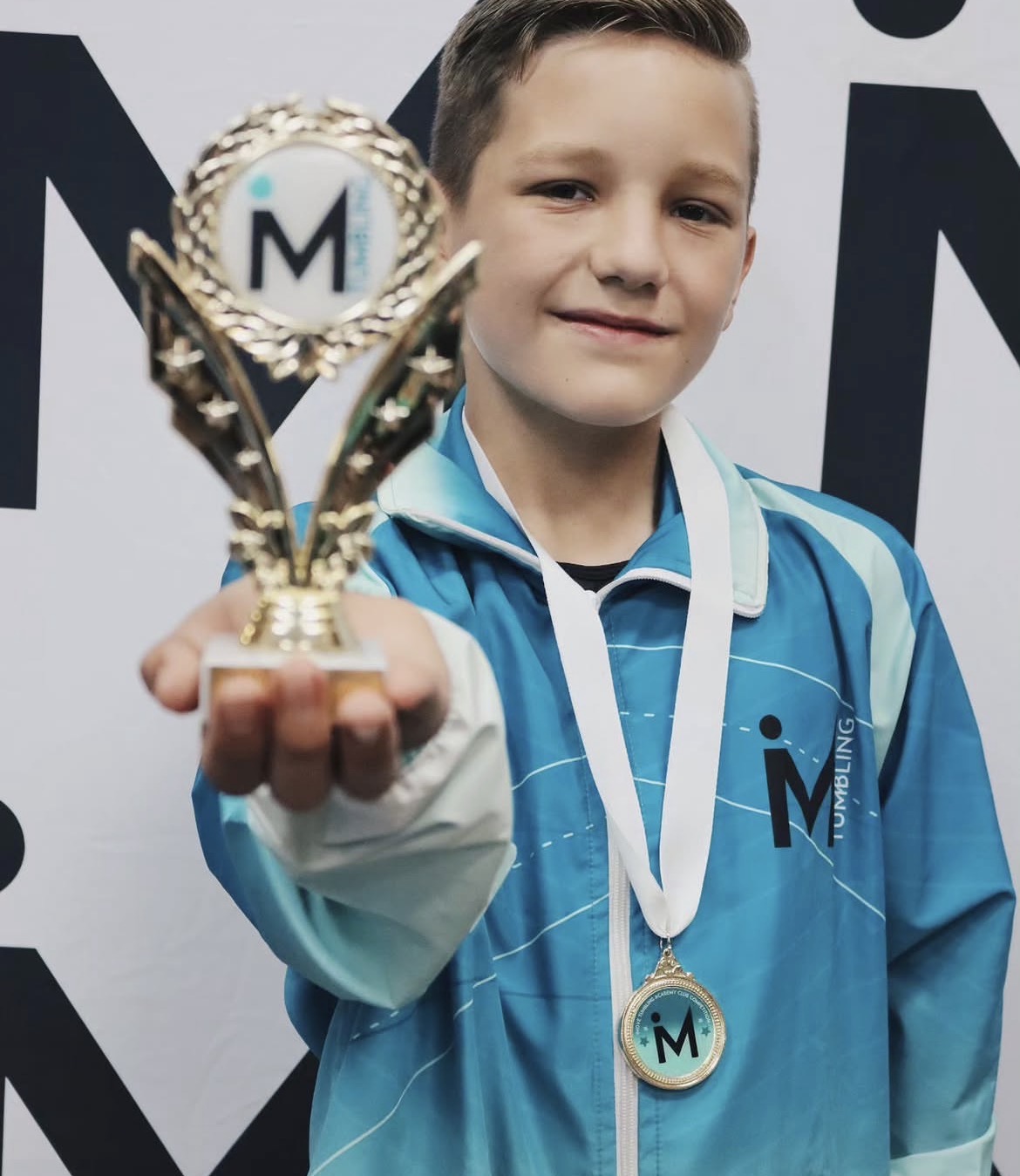 iMove athlete with medal and trophy