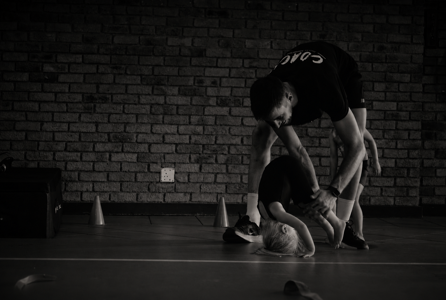 Coach giving one-on-one private tumbling coaching to a gymnast