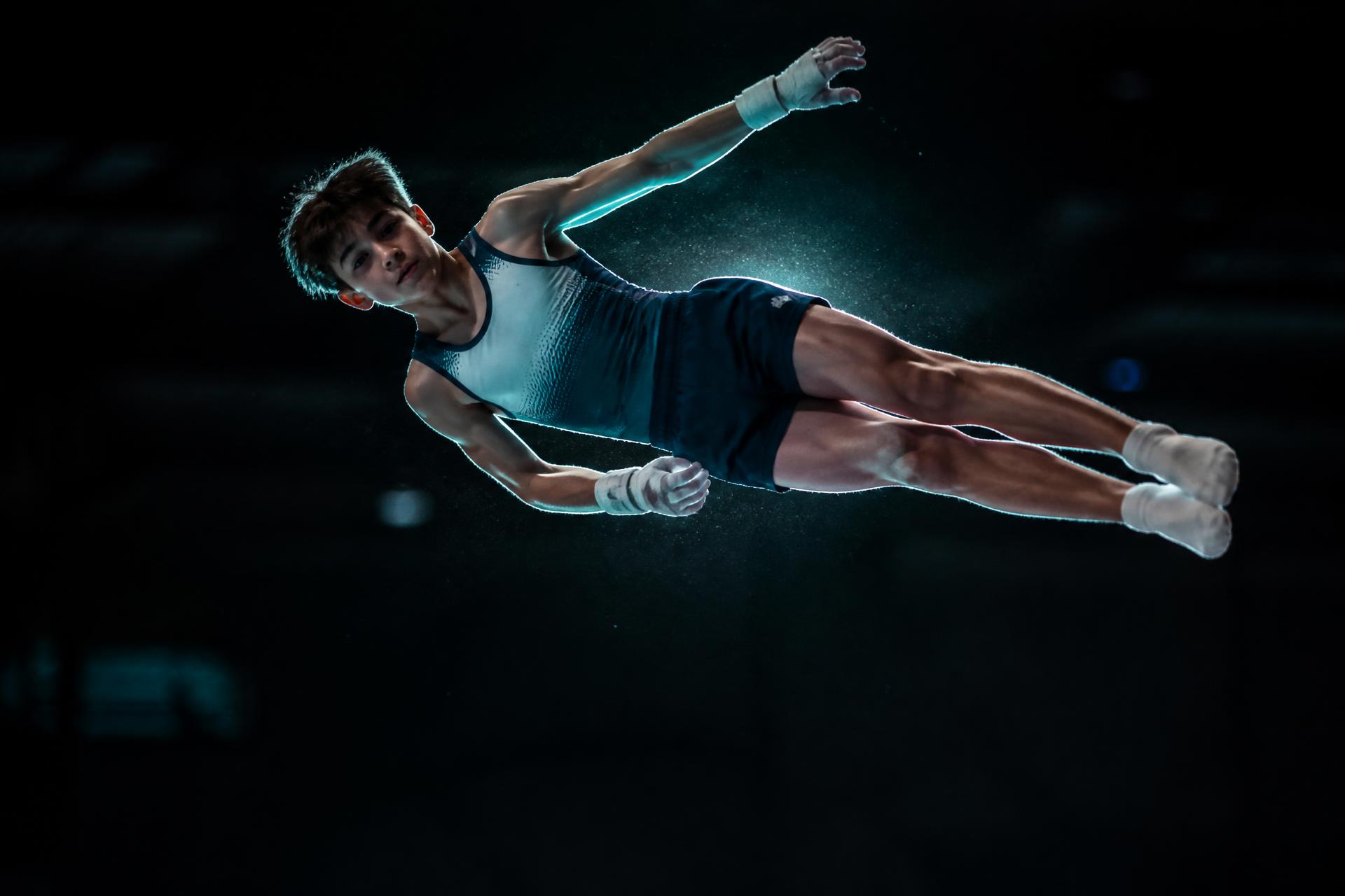 Tumbling athlete fully extended mid-air during a powerful pass